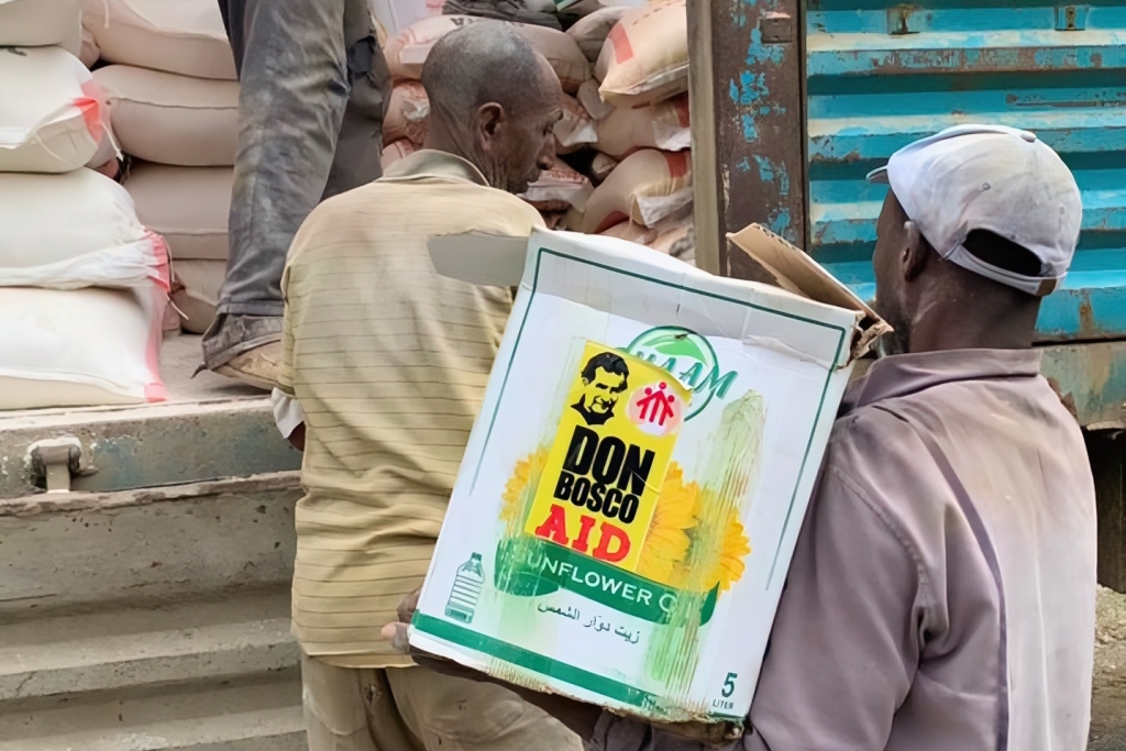 Loading sacks of rice onto a truck.